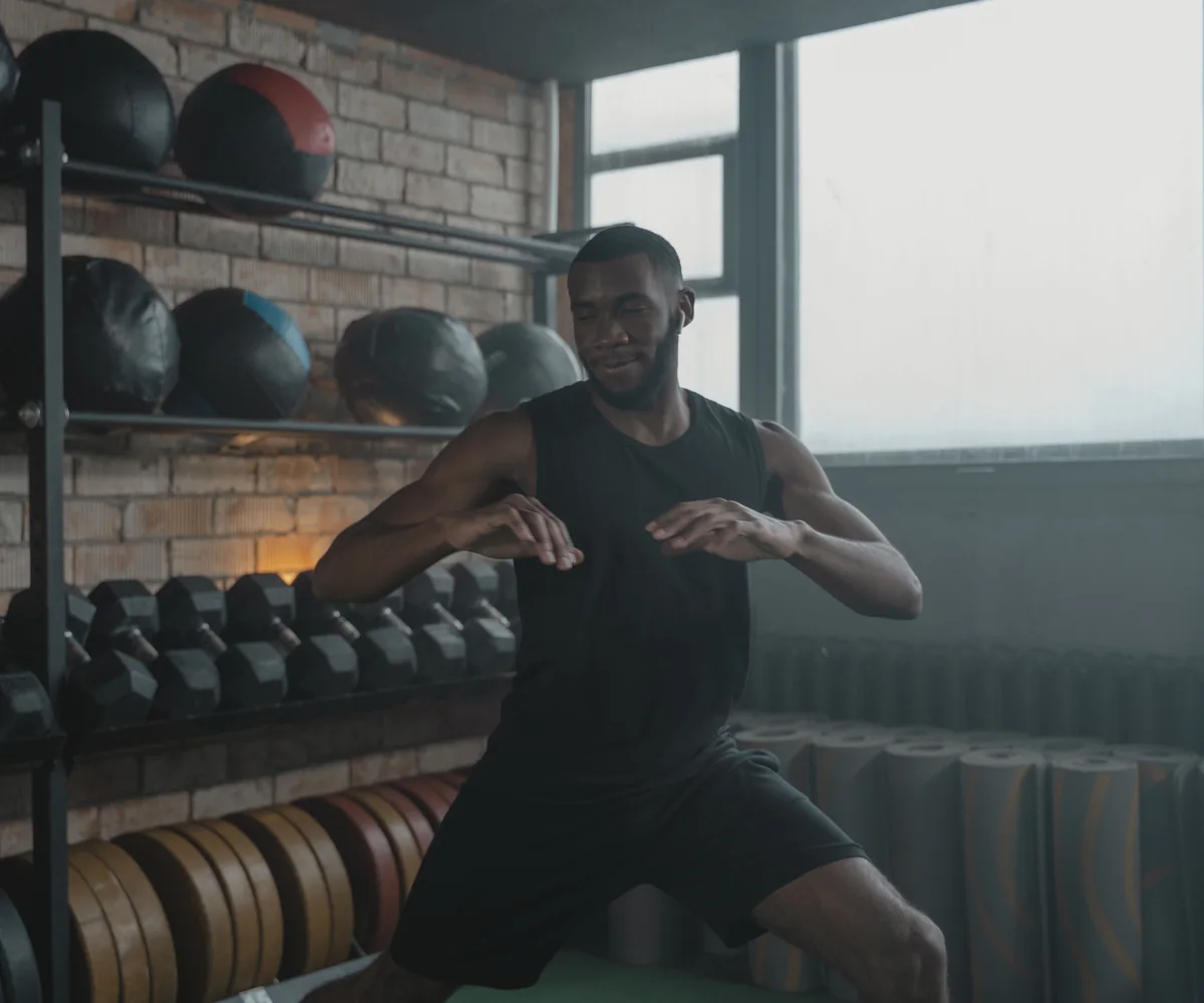 African male athlete exercising in a modern gym